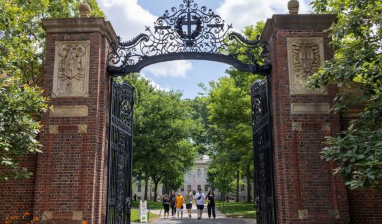People walk through the campus of Harvard University on June 29 in Cambridge, Massachusetts.