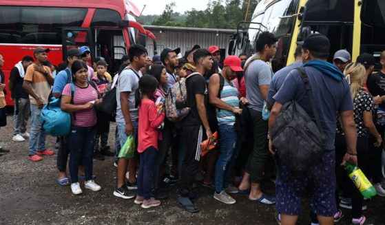 Illegal immigrants wait to get inside a bus that will take them to the border between Honduras and Guatemala and continue their route to the United States on Aug. 24.