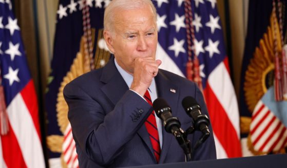 President Joe Biden coughs while delivering remarks at the White House on Wednesday in Washington, D.C.
