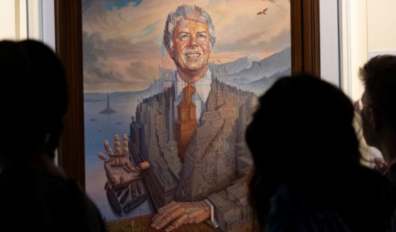 Visitors pass a portrait of President Jimmy Carter during a celebration of his 99th birthday held at The Carter Center in Atlanta on Saturday.