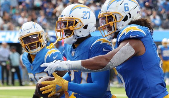 J.C. Jackson, center, of the Los Angeles Chargers celebrates an interception with teammates during the third quarter of their game against the Miami Dolphins in Inglewood, California, on Sept. 10.