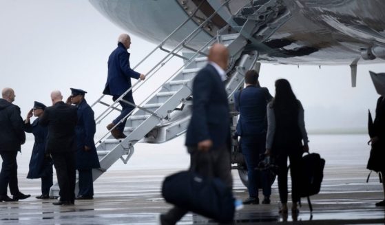 President Joe Biden climbs the stairs of Air Force One on Joint Base Andrews in Maryland on Tuesday.