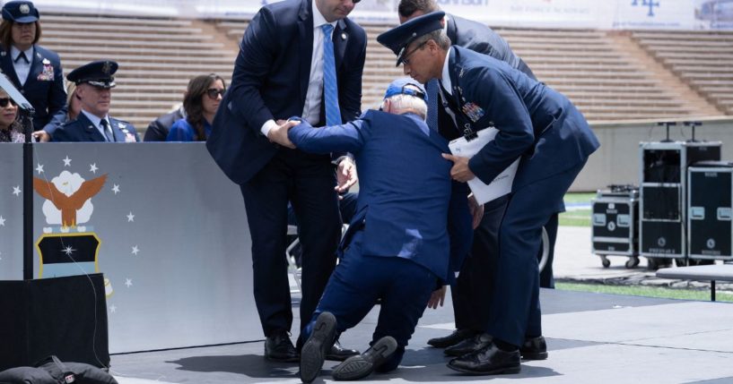 President Joe Biden is helped up after falling during the United States Air Force Academy graduation ceremony in Colorado Springs on June 1.