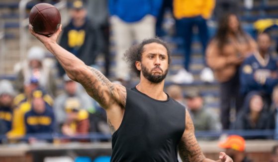 Former NFL quarterback Colin Kaepernick participates in a throwing exhibition during halftime of the University of Michigan spring football game at Michigan Stadium in Ann Arbor on April 2, 2022.