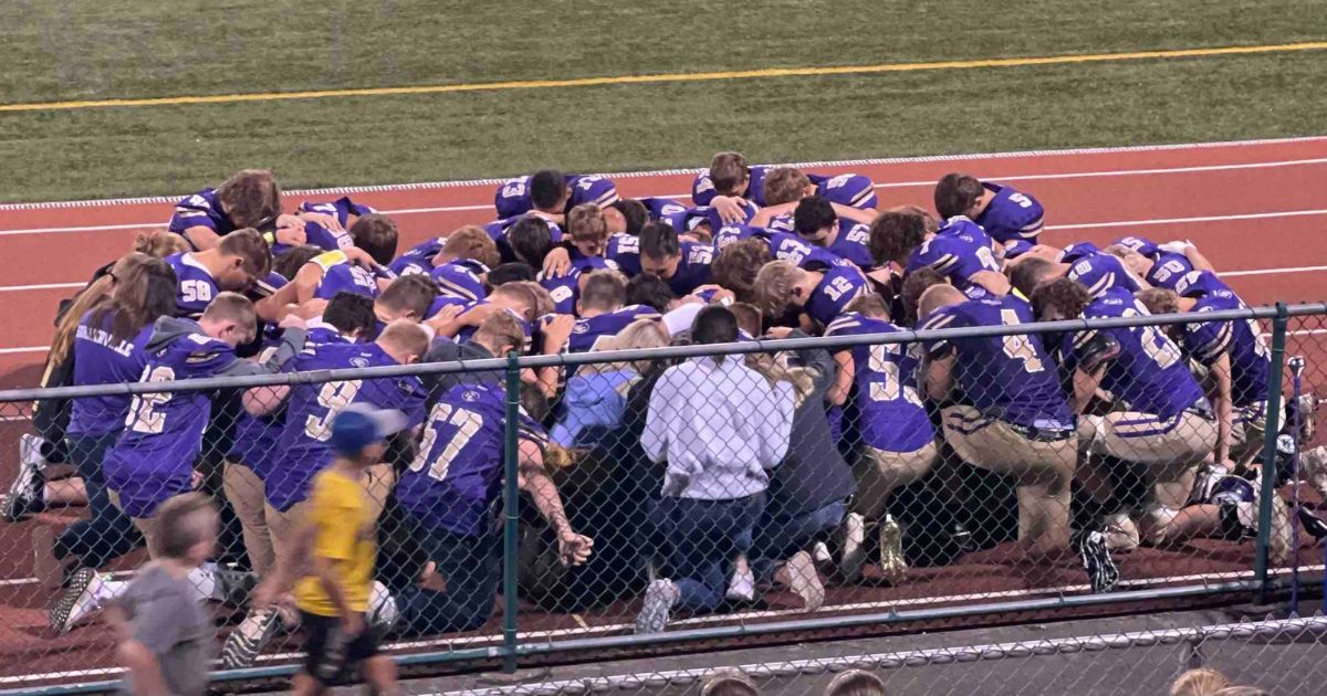 Members of the Karns City High School football team in Pennsylvania pray for their teammate, Mason Martin, on Friday.