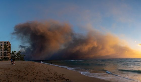Wildfires in Lahaina are seen from the neighboring Maui resort of Kaanapali Alii in Kaanapali, Hawaii, on Aug. 8.
