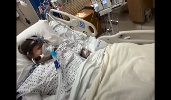 Laura Barajas, 40, lies in her hospital bed.