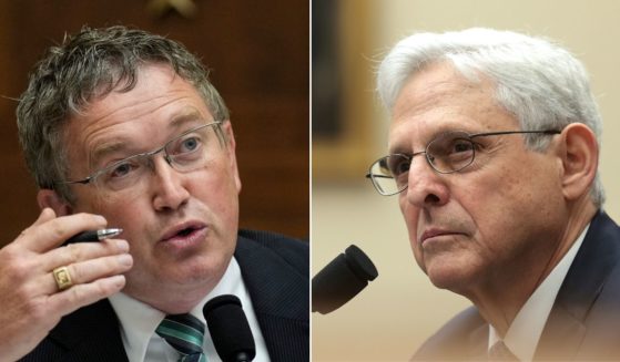Kentucky GOP Rep. Thomas Massie, left, confronted Attorney General about "sending grandmas to prison" while a man seen on multiple videos urging people to charge into the U.S. Capitol on Jan. 6, 2021, was only charged with a single misdemeanor. "The American public isn't buying it," Massie told Garland.