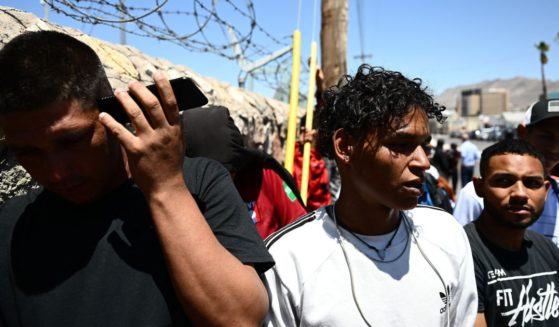 Illegal immigrants from Venezuela wait to turn themselves in for processing to U.S. Border Patrol agents after crossing from Mexico into El Paso, Texas, on May 9.