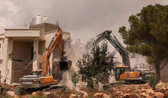 Bulldozers demolish a Palestinian house built without a permit from the Israeli authorities in Area C on Aug. 29.