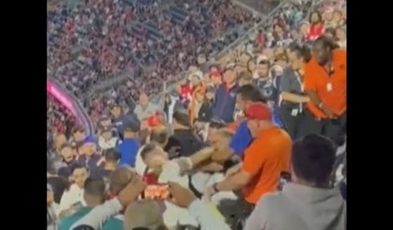 A fight breaks out between fans at a Miami Dolphins-New England Patriots game in Massachusetts on Sunday.