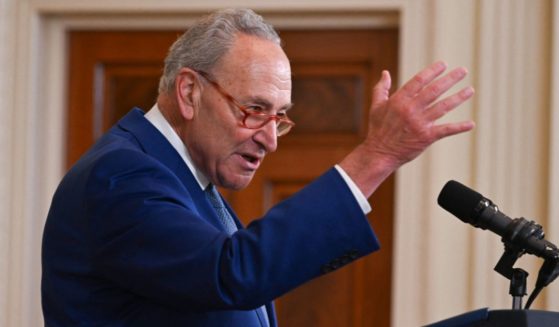 Senate Majority Leader Chuck Schumer gestures while speaking in the East Room of the White House in Washington on Aug. 16.