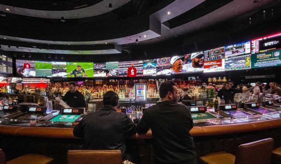 Gamblers flow into Caesars Sports Book at Caesars Palace Hotel & Casino in Las Vegas, Nevada, to place bets for Super Bowl LVII on Feb. 12.