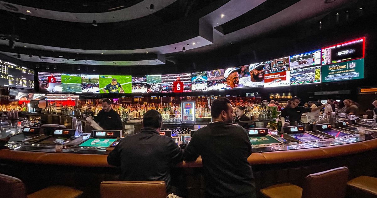 Gamblers flow into Caesars Sports Book at Caesars Palace Hotel & Casino in Las Vegas, Nevada, to place bets for Super Bowl LVII on Feb. 12.