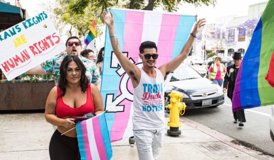 Participants march down University Avenue during the Drag March for Trans Rights at Urban Mo's Bar & Grill on June 18 in San Diego, California. New legislation could strip Californians of their parental rights for refusing to accommodate a child who wants to change genders.