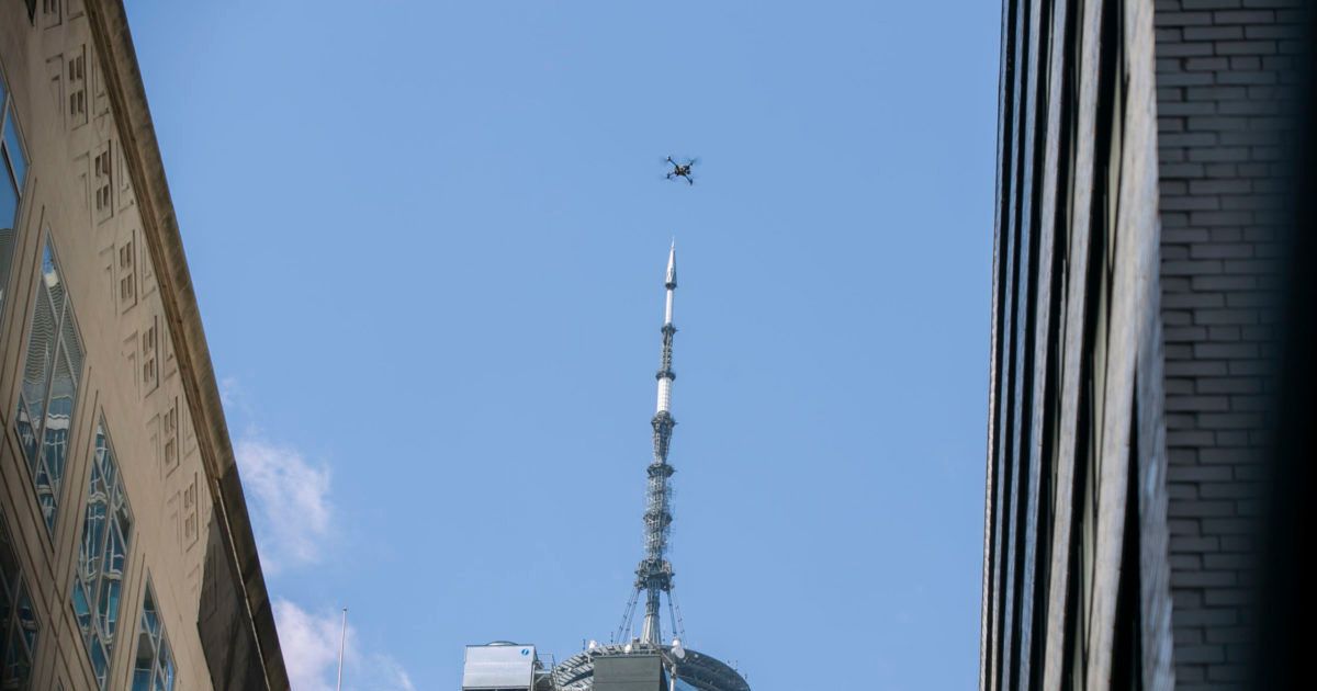 An NYPD or FDNY drone flies over the site of a partially collapsed parking garage as One World Trade Center is visible in the background in New York City on April 19.