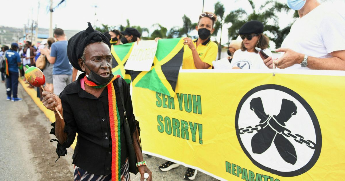 People calling for slavery reparations protest outside the entrance of the British High Commission during the visit of the Duke and Duchess of Cambridge in Kingston, Jamaica, on March 22, 2022.