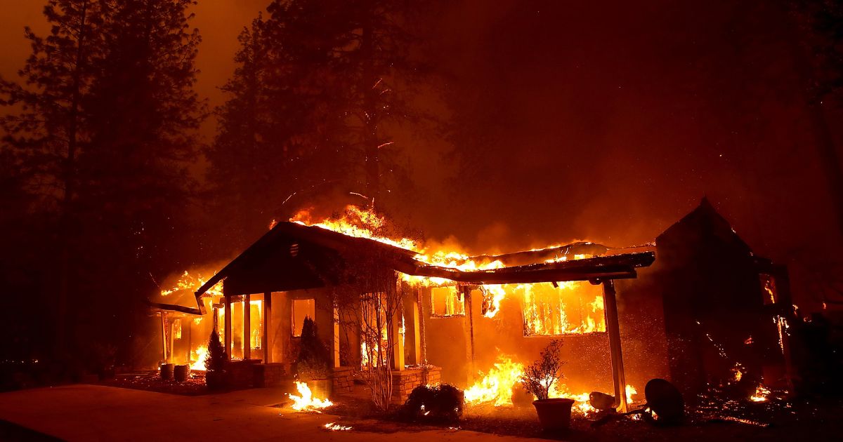 A home burns as the Camp Fire moves through the area on November 8, 2018, in Paradise, California.