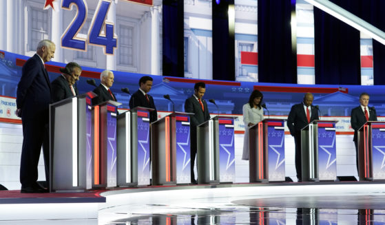 Republican presidential candidates pray on stage before the first Republican primary debate hosted by Fox News in Milwaukee, Wisconsin, on Aug. 23.