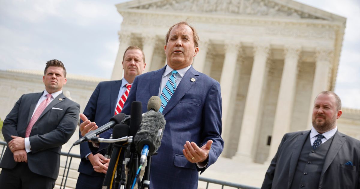 Texas Attorney General Ken Paxton (C) talks to reporters with Missouri Attorney General Eric Schmitt (2nd L) and Texas Solicitor General Judd Stone (R) in front of the U.S. Supreme Court after arguments in their case about Title 42 on April 26, 2022 in Washington, DC.