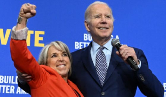 New Mexico Gov. Michelle Lujan Grisham gestures next to President Joe Biden during a rally hosted by the Democratic Party of New Mexico in Albuquerque on Nov. 3, 2022.
