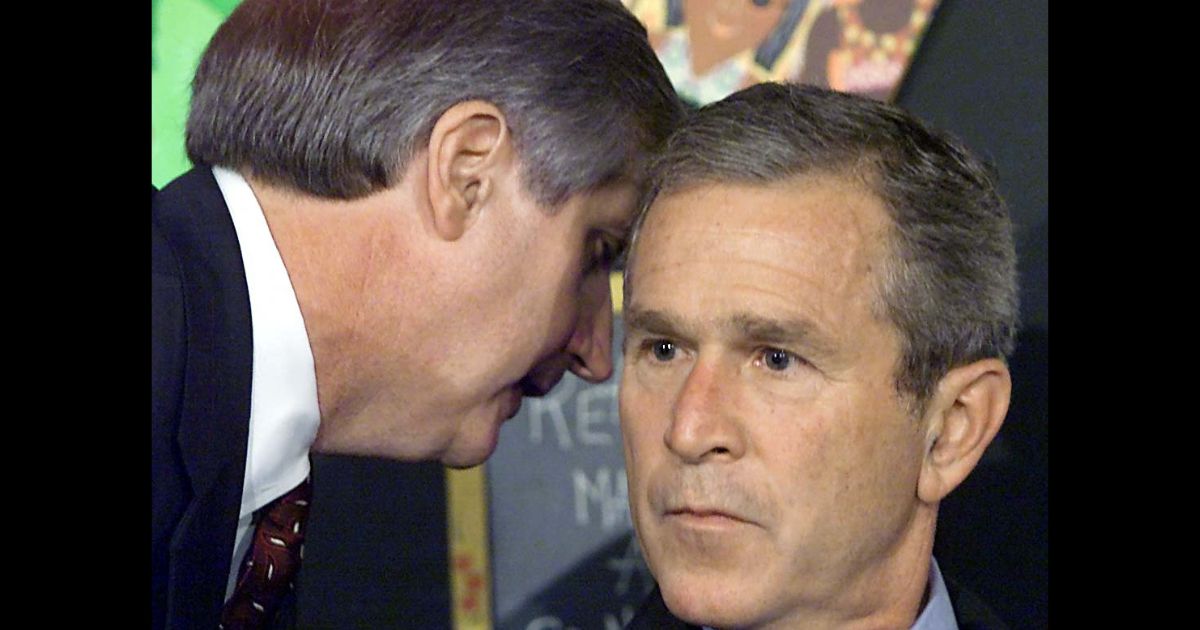 Then-President George W. Bush has his early morning school reading event interupted by his Chief of Staff Andrew Card (L) shortly after news of the New York City airplane crashes was available in Sarasota, Florida.