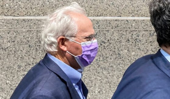 Former U.S. Rep. Stephen Buyer, left, trails his lawyer as he leaves Manhattan federal court after pleading not guilty to charges that he participated in an insider trading scheme while working as a consultant, July 27, 2022, in New York.