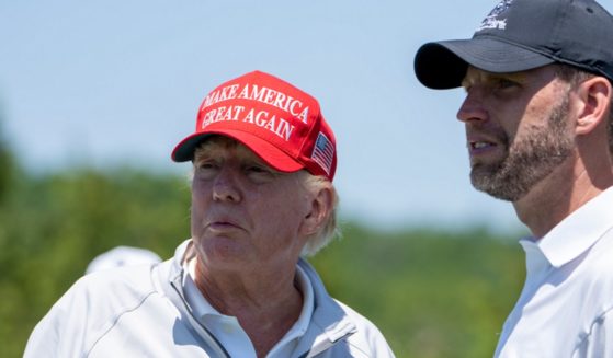 Former President Donald Trump and his son Eric are pictured in a file photo from the May LIV Golf Pro-Am at Trump National Golf Club in Sterling, Virginia.