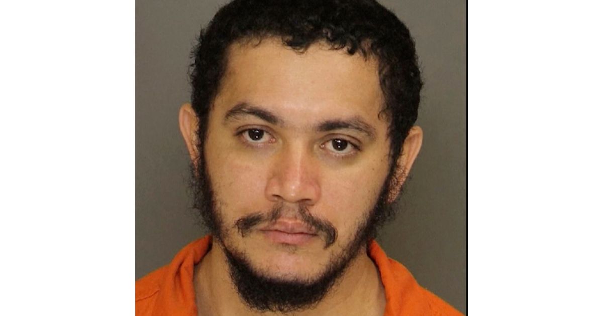 This booking photo shows Danelo Cavalcante, convicted of killing his girlfriend and wanted in his native Brazil in a separate slaying.