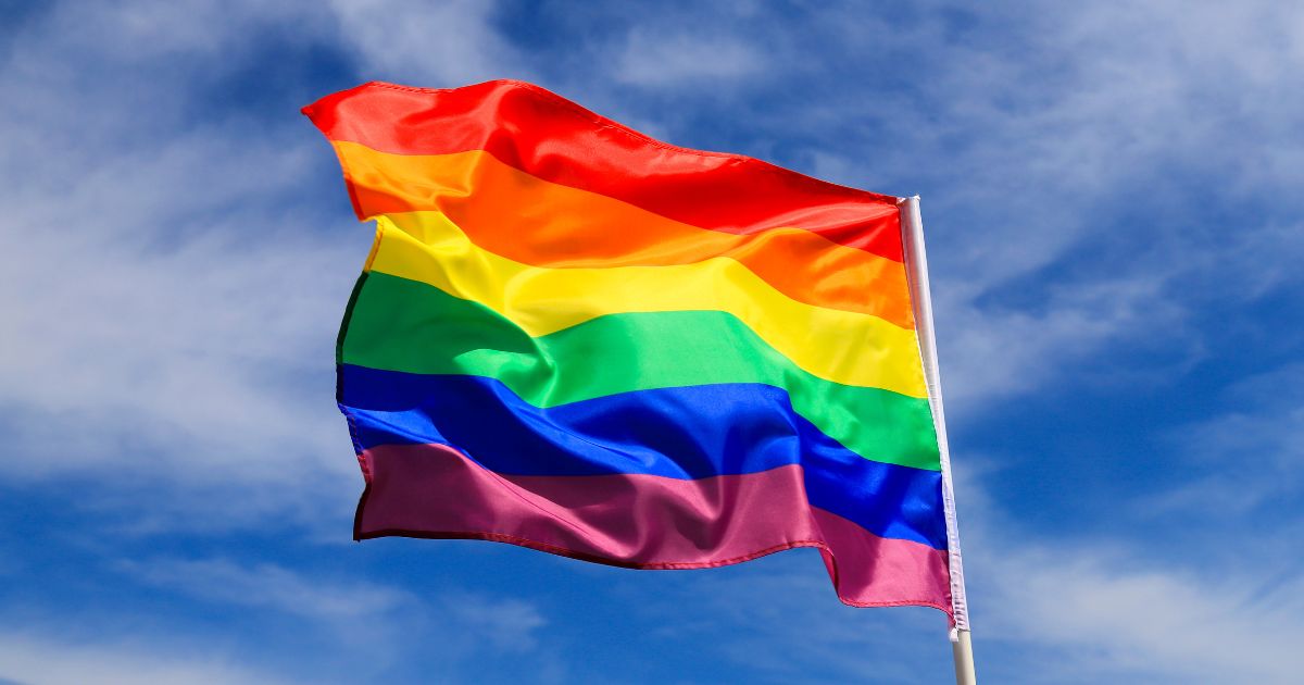 An LGBT flag flies in this stock image.