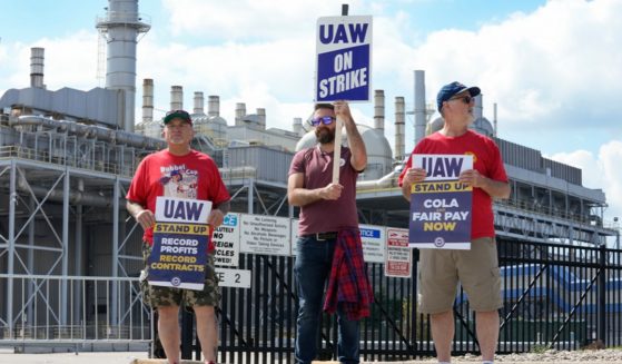 Striking members of the United Auto Workers walk a picket line Friday at the Ford Motor Co. Michigan Assembly Plant in Wayne, Michigan.
