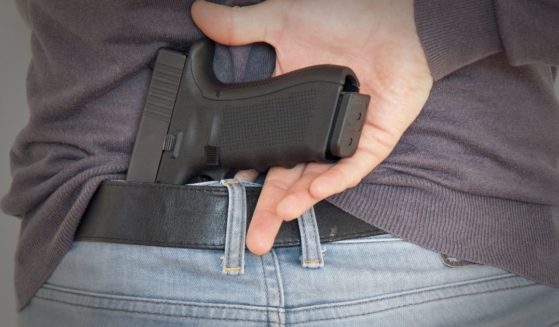 A man draws a gun in the above stock image.