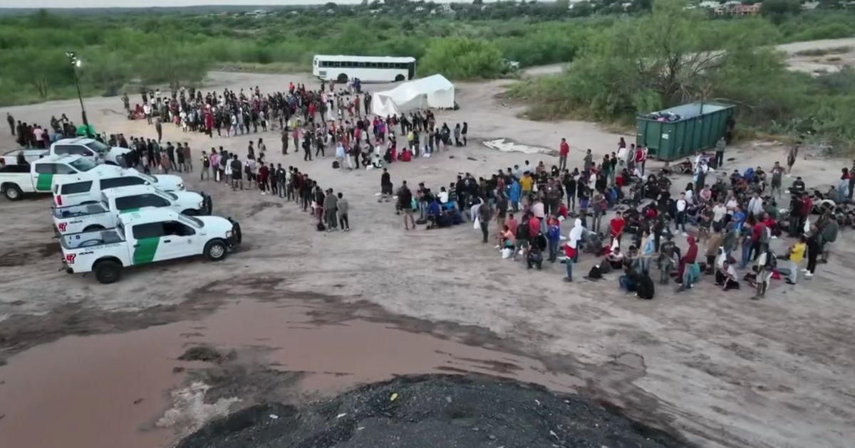 hundreds of illegal immigrants being processed by U.S. Border Patrol officers