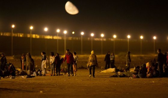Illegal immigrants arrive at a gate in the border fence after crossing from Ciudad Juarez, Mexico, into El Paso
