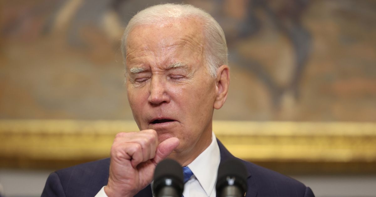 U.S. President Joe Biden coughs as he delivers remarks on the contract negotiations between the United Auto Workers and auto companies in the Roosevelt Room at the White House on September 15, 2023 in Washington, DC.