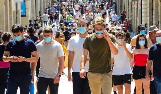 People stroll down Bordeaux's main shopping street Sainte-Catherine, where wearing a mask is compulsory as of Aug. 15, 2020, to prevent the spread of the novel coronavirus COVID-19.