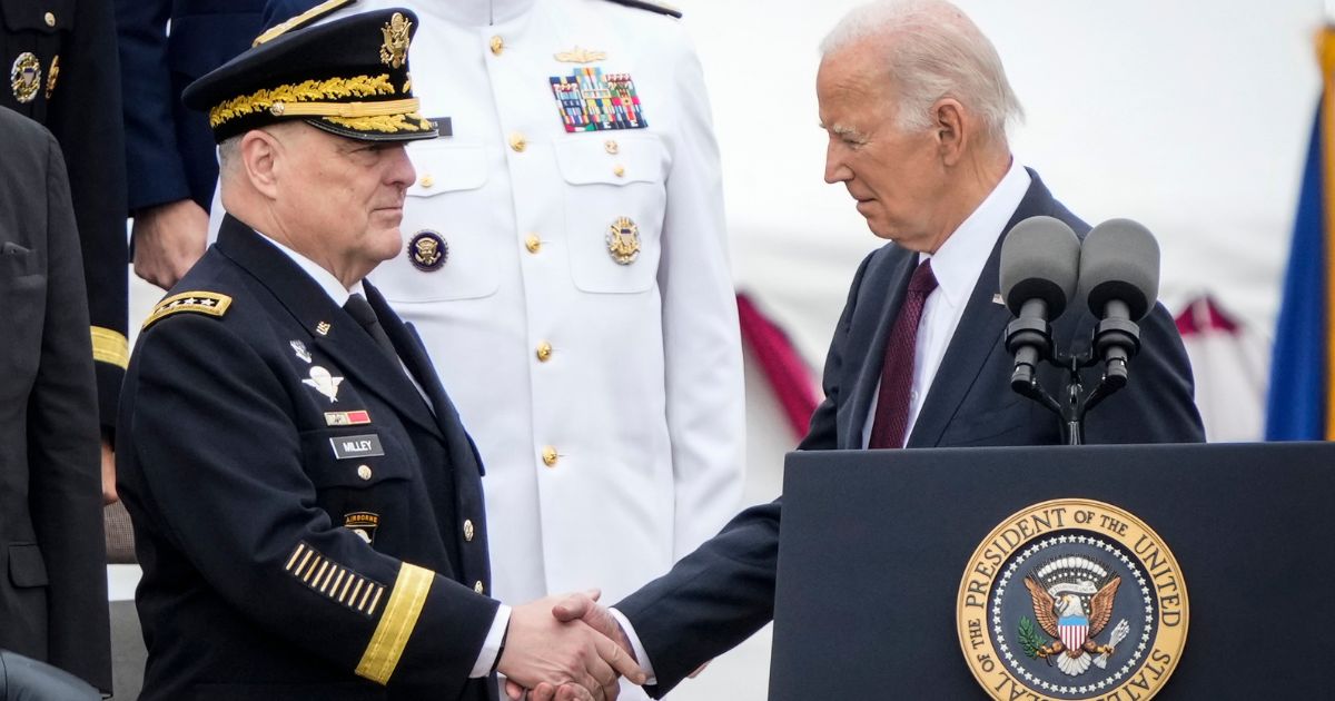 U.S. President Joe Biden shakes hands with outgoing Chairman of the Joint Chiefs of Staff General Mark Milley as Biden arrives for an Armed Forces Farewell Tribute in Milley's honor at Summerall Field at Joint Base Myer-Henderson Hall September 29, 2023 in Arlington, Virginia.