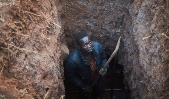 A gold miner poses for a portrait inside his trench at a gold mining site in Zvishavane, Zimbabwe, on Aug. 22.