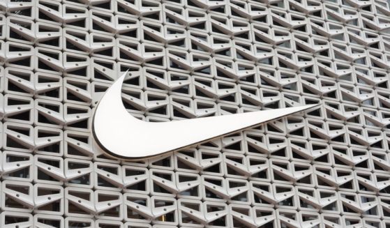 The Nike logo hangs above the entrance to the Nike store on Dec. 21, 2021, in Miami Beach, Florida.