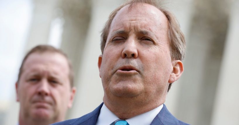 Texas Attorney General Ken Paxton talks to reporters after the U.S. Supreme Court heard arguments in their case about Title 42 on April 26, 2022, in Washington, D.C.
