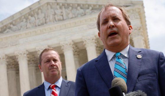 Texas Attorney General Ken Paxton (R) and Missouri Attorney General Eric Schmitt talk to reporters after the U.S. Supreme Court heard arguments in their case about Title 42 on April 26, 2022, in Washington, D.C.