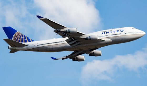 A United Airlines plane flies in this stock image