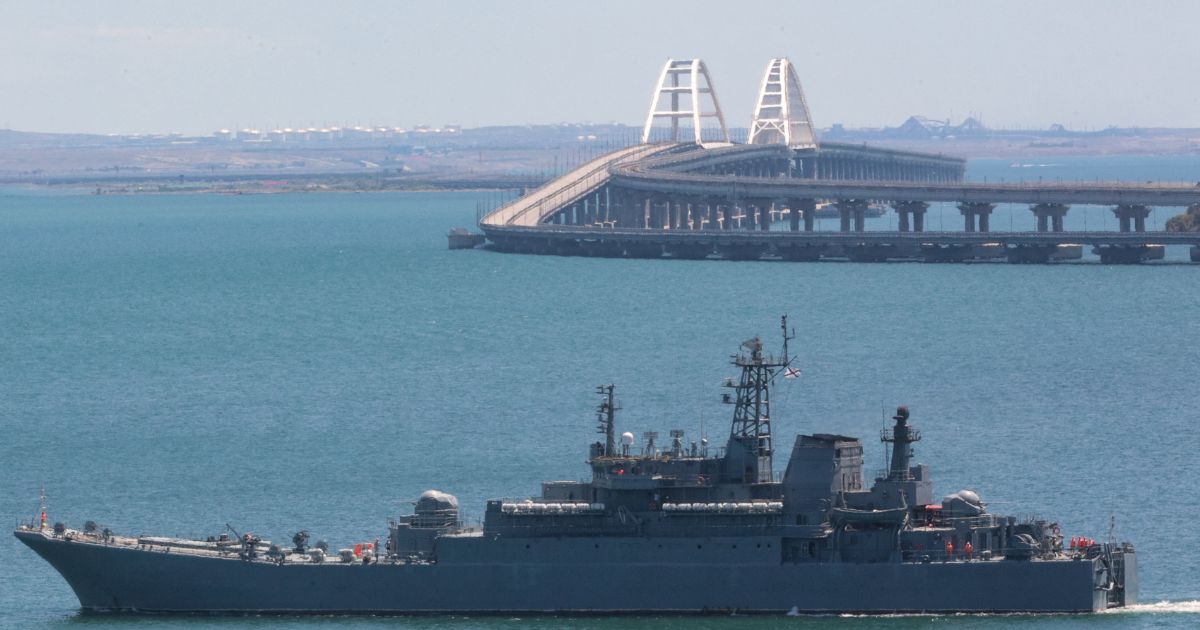 A picture taken on July 17 shows a Russian warship sailing near the Kerch bridge, linking the Russian mainland to Crimea, following an attack claimed by Ukrainian forces.