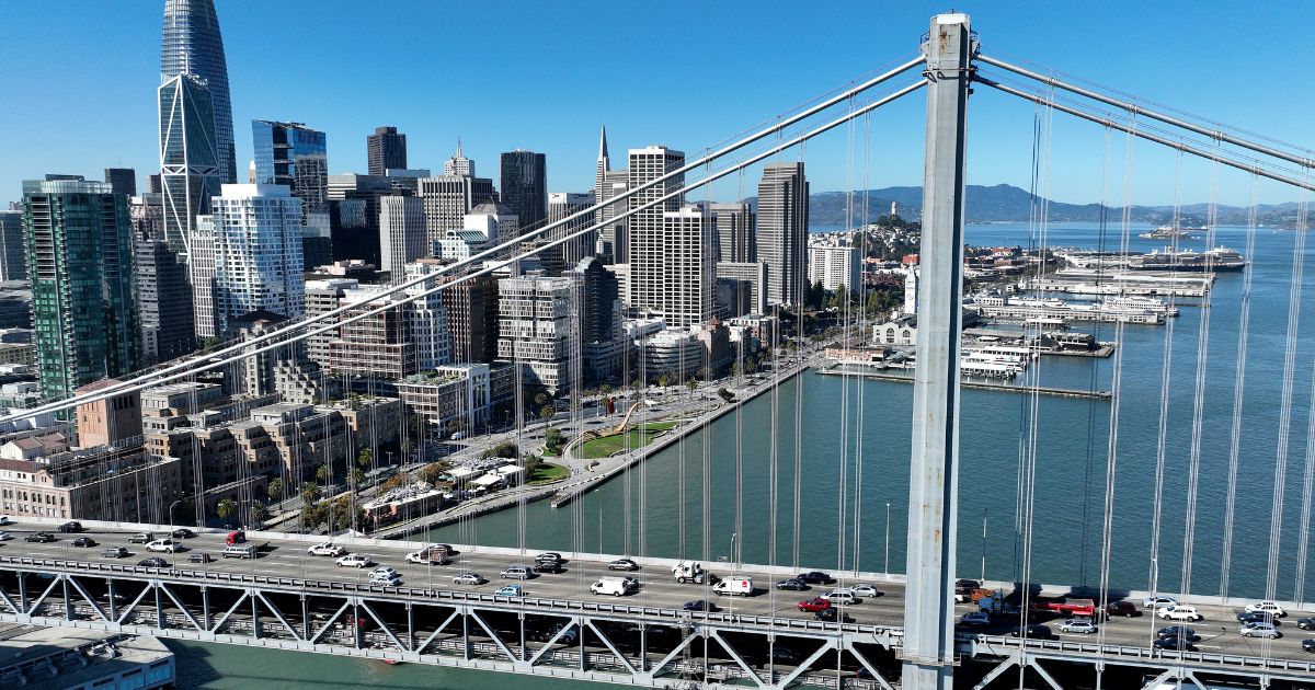 In an aerial view, cars drive by the San Francisco skyline as they cross the San Francisco-Oakland Bay Bridge on October 27, 2022 in San Francisco, California. (Justin Sullivan / Getty Images)