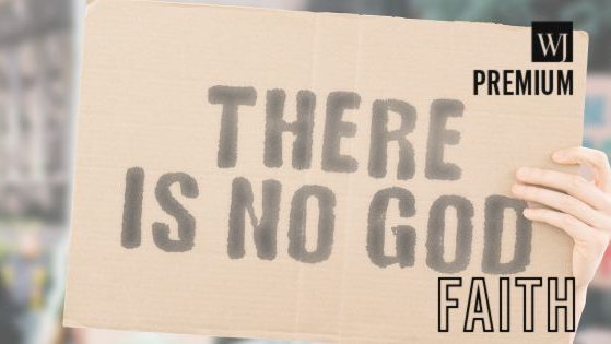 A man holds a sign saying "There is no God" in this stock image.