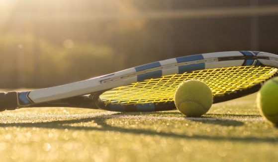 This stock photo shows a tennis racket and tennis balls.