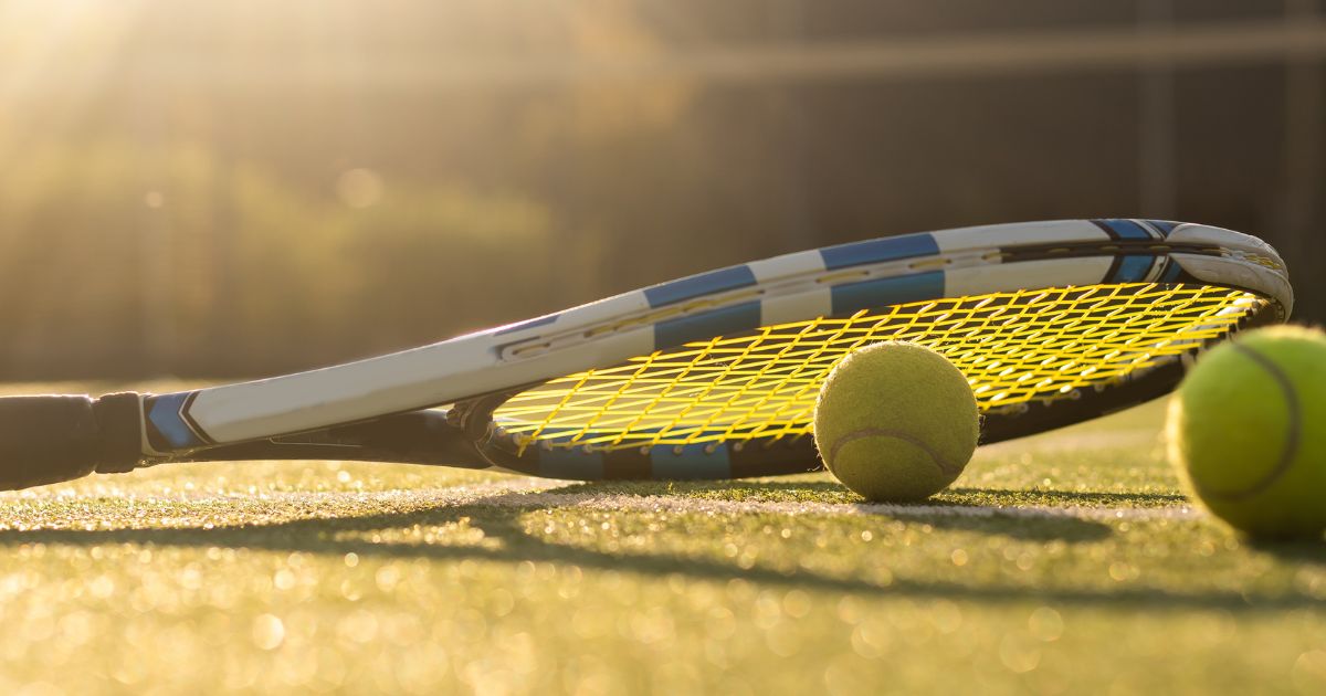 This stock photo shows a tennis racket and tennis balls.