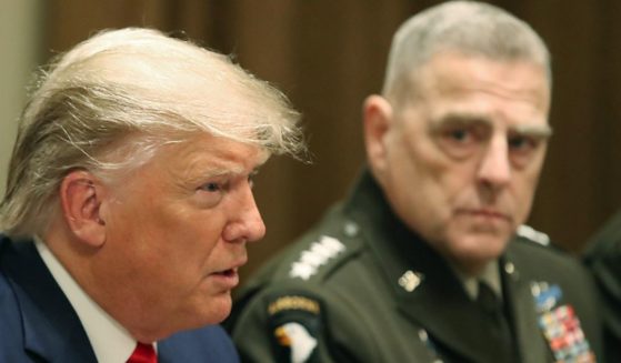 Then-President Donald Trump speaks as Joint Chiefs of Staff Chairman, Army Gen. Mark Milley looks on after getting a briefing from senior military leaders in the Cabinet Room at the White House on Oct. 7, 2019, in Washington, D.C.