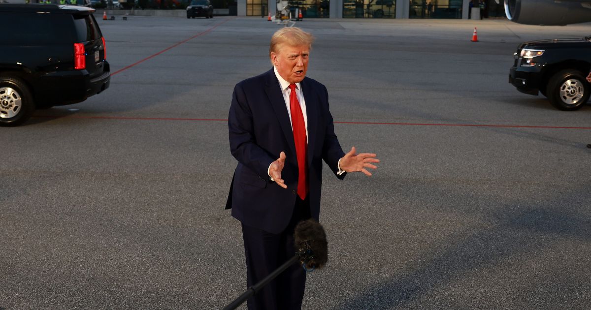 Former U.S. President Donald Trump speaks to the media at Atlanta Hartsfield-Jackson International Airport after surrendering at the Fulton County jail on August 24, 2023 in Atlanta, Georgia.
