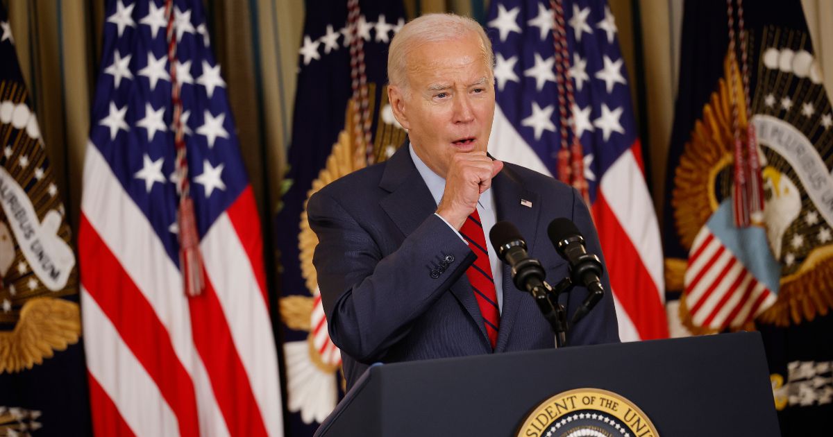 U.S. President Joe Biden coughs while delivering remarks to an audience of leaders from the International Longshore and Warehouse Union (ILWU) and the Pacific Maritime Association (PMA) during an event to congratulate them on finalizing a new labor contract in the State Dining Room at the White House on September 6, 2023 in Washington, DC.